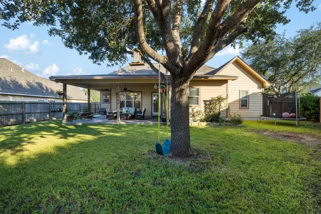 a view of house with a backyard
