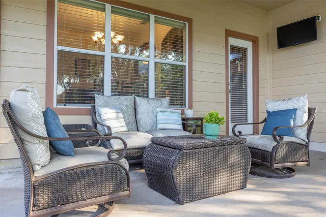 a living room with furniture and a floor to ceiling window