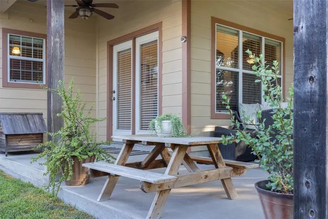 a view of a house with backyard and sitting area