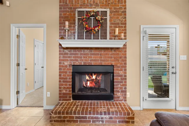 a living room with a fireplace windows and a fireplace