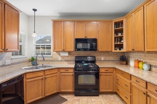 a kitchen with stainless steel appliances a stove sink microwave and cabinets