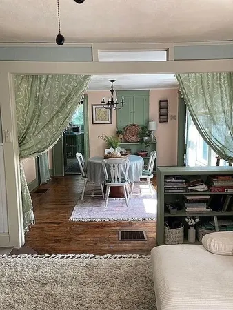 a living room with furniture and a piano