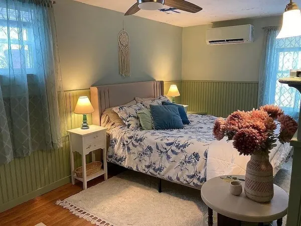 a bedroom with a bed and a couch