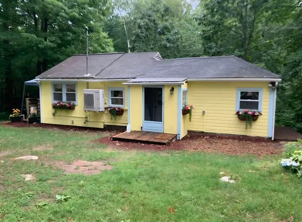 a view of a patio with chairs and a flower pot