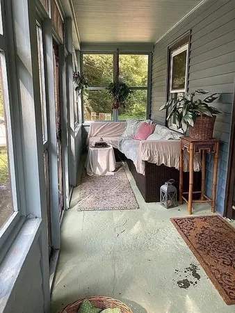 a bedroom with furniture and a window