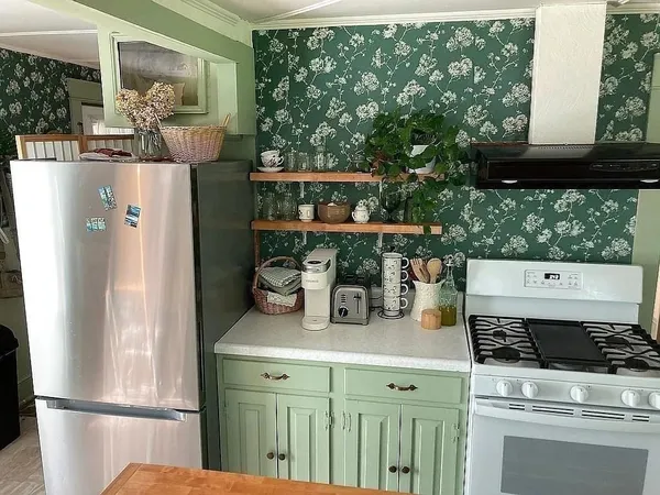 a kitchen with a refrigerator and a stove
