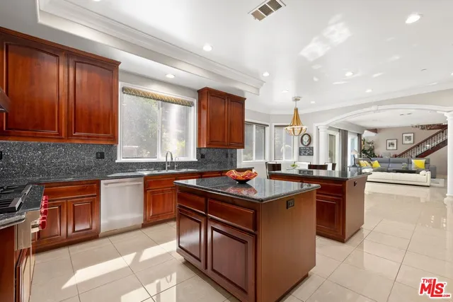 a living room with furniture a floor to ceiling window and potted plant