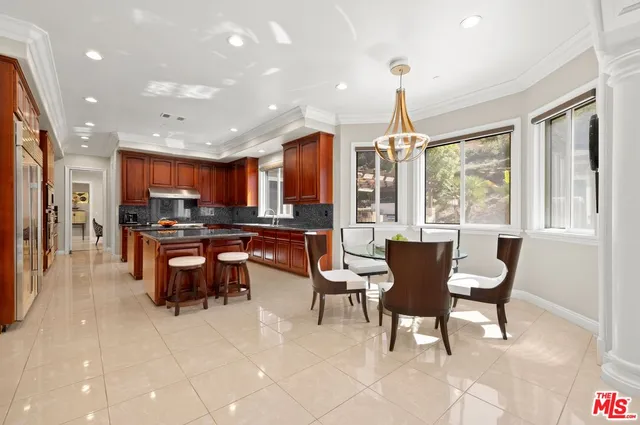 a living room with furniture a fireplace and a floor to ceiling window