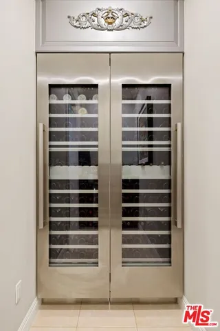 a bedroom with two beds and a chair