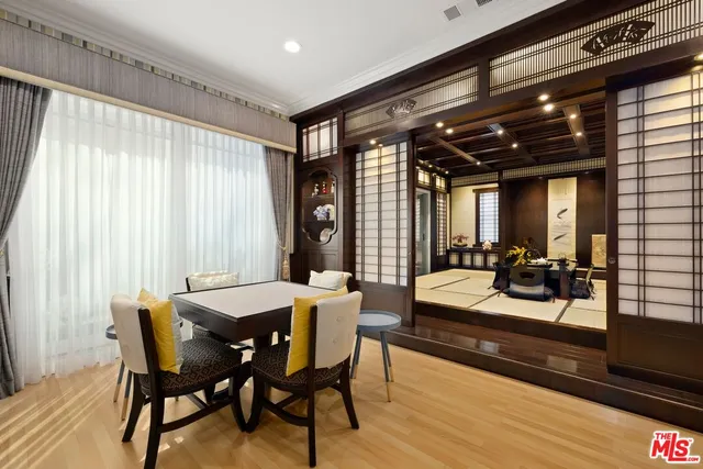 a bedroom with bed and wooden floor