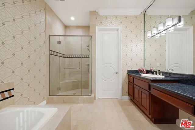 a bathroom with a sink a toilet a mirror and shower