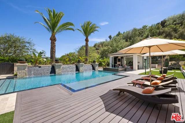 a view of a balcony with chairs and wooden floor