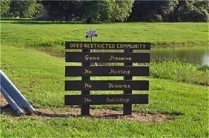 a view of a bench sitting in a yard with wooden fence