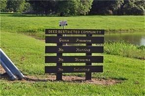 a view of a bench sitting in a yard with wooden fence