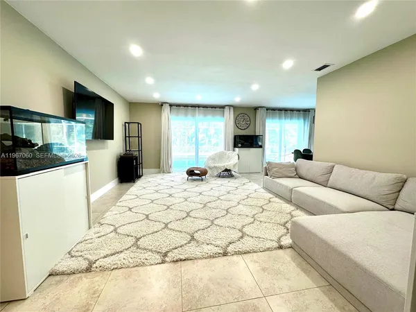 a large bedroom with a bed and a large mirror
