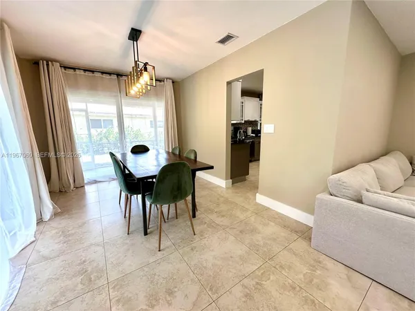 a dining room with furniture and a large window