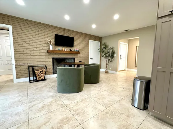 a living room with fireplace furniture and a flat screen tv