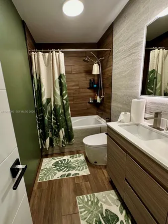 a bathroom with a sink a toilet and mirror