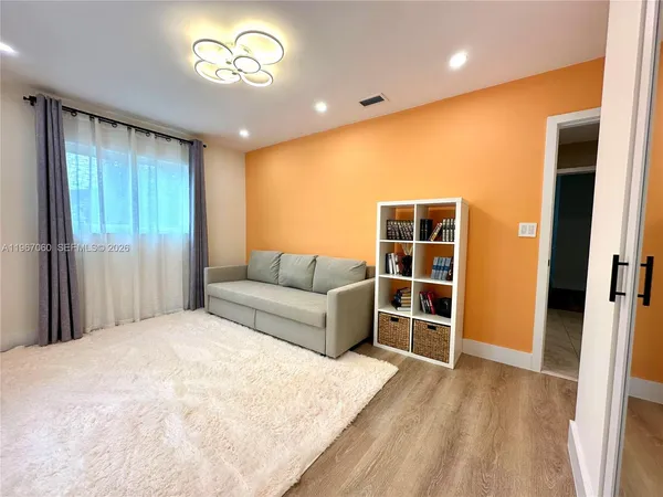 a spacious bedroom with a bed and a window