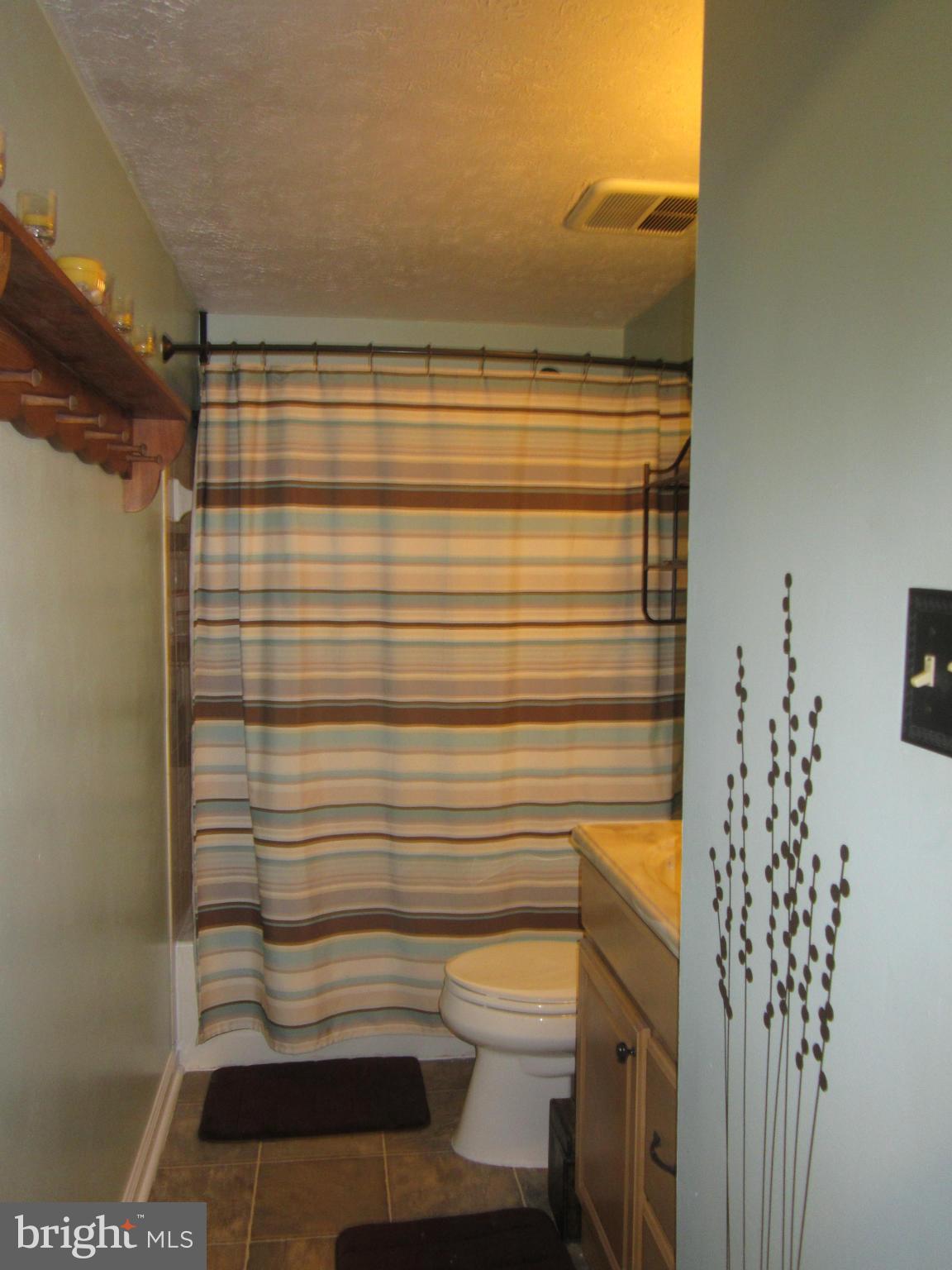 5023 Clifford Road Perry Hall, MD 21128 - Photo 17 of 28 a bathroom with a toilet and a shower curtain