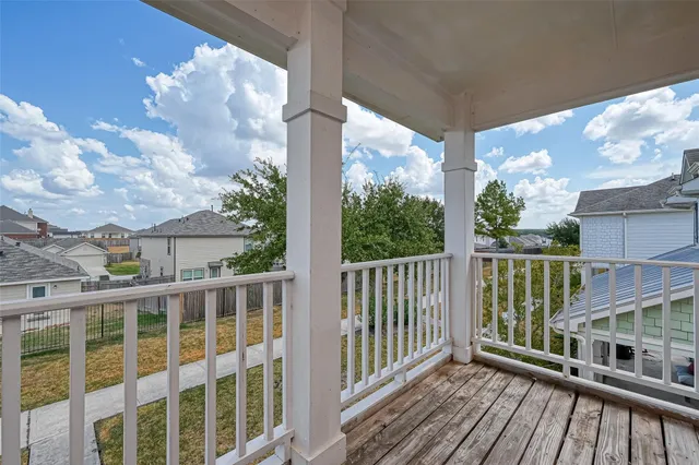 a view of a balcony with wooden floor