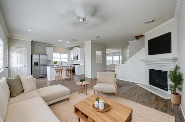 a living room with furniture kitchen view and a fireplace