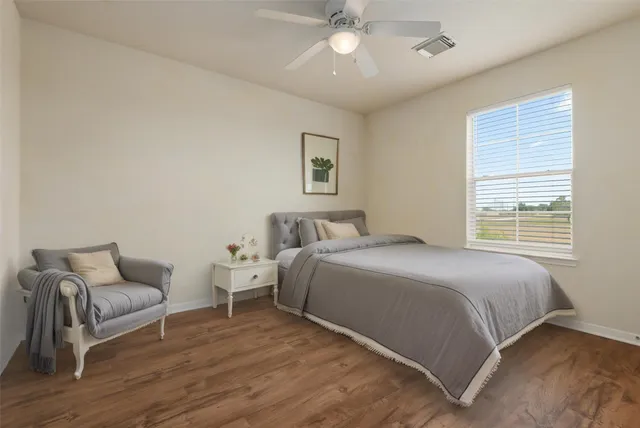 a spacious bedroom with a bed and a couch