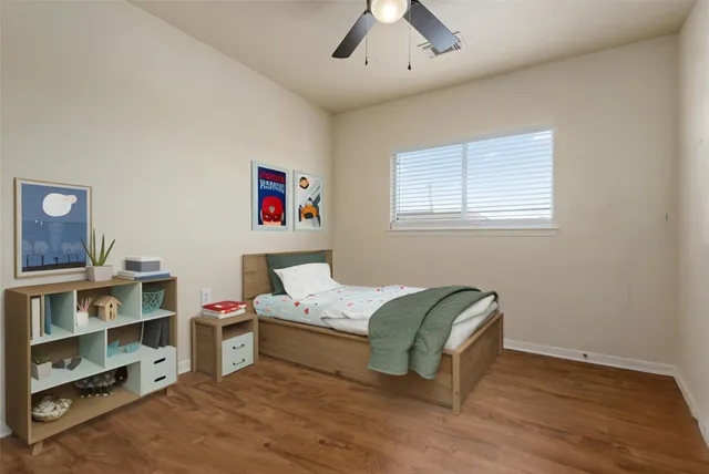 a bedroom with a bed and a bookshelf