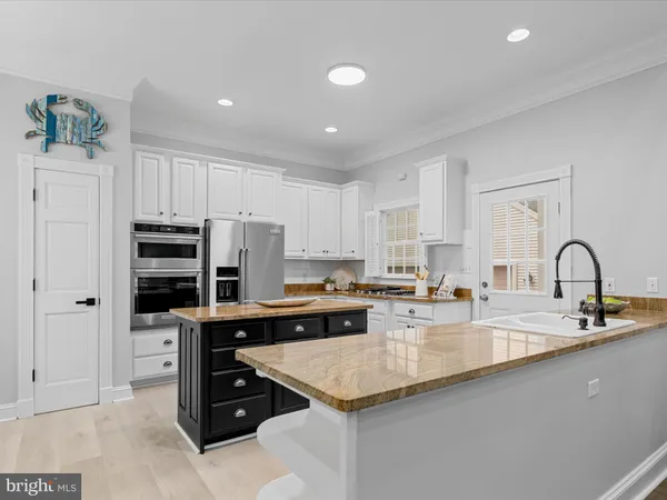 a kitchen with a stove a sink and a refrigerator