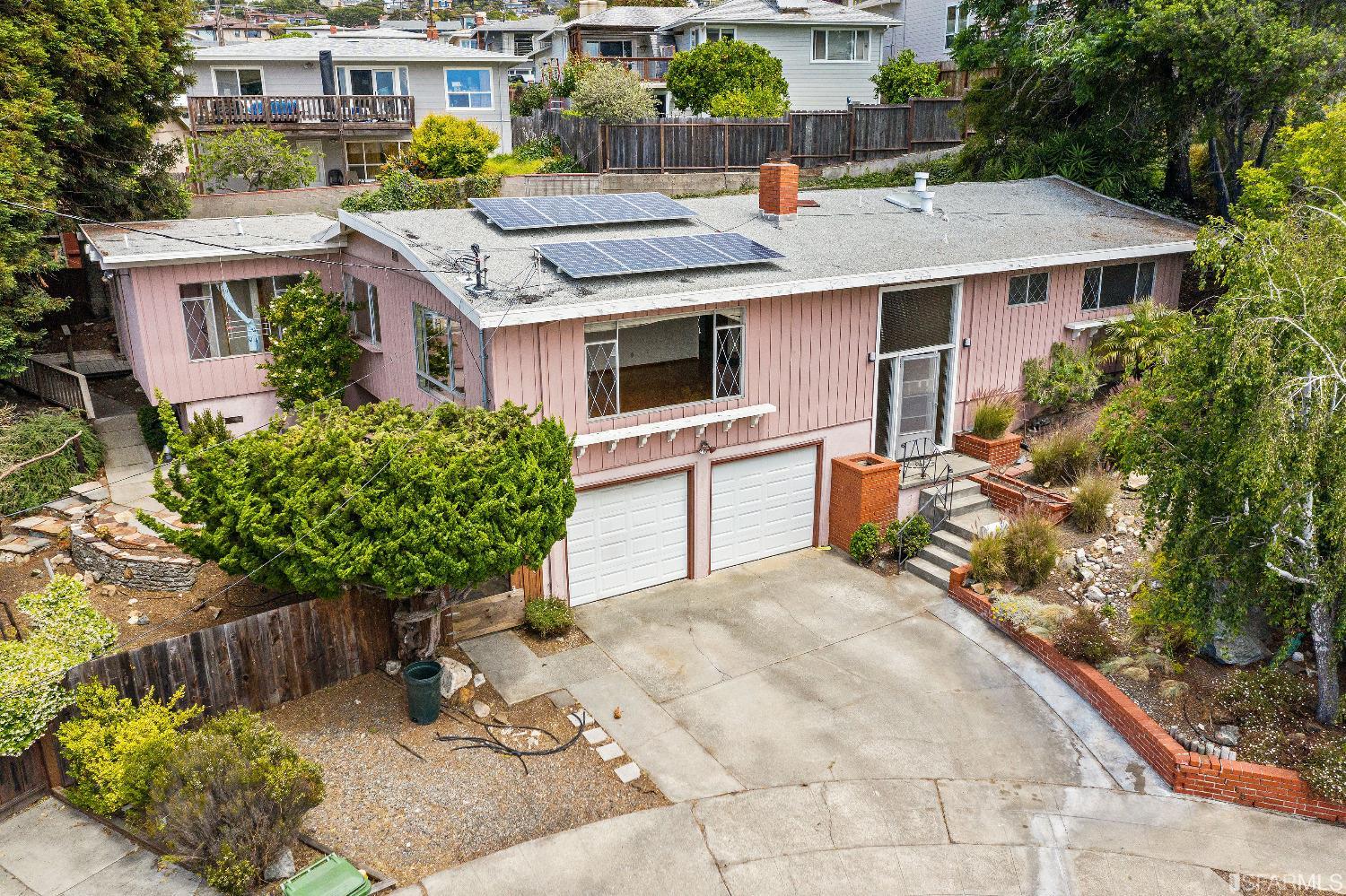 a aerial view of a house with yard and seating area