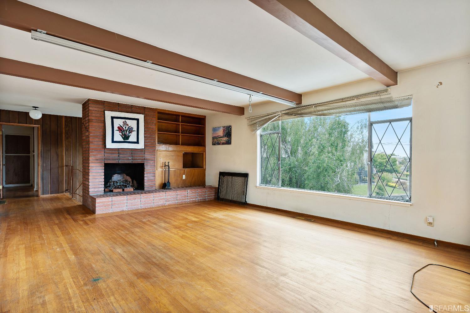 1773 Walnut Street El Cerrito, CA 94530 - Photo 3 of 43 a view of an empty room with a fireplace and a window