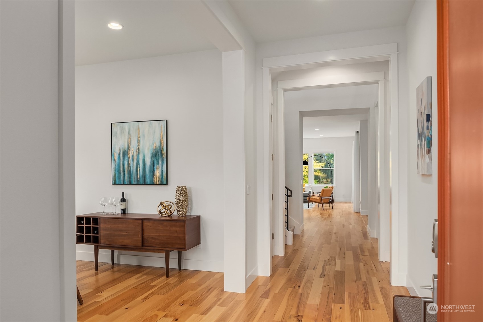 3322 219th Place Southeast Bothell, WA 98021 - Photo 2 of 37 a view of a hallway with wooden floor and a bathroom