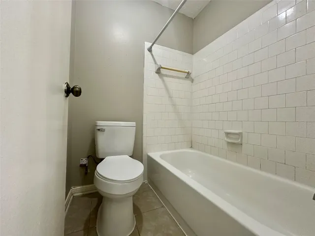 a bathroom with a toilet and a bathtub