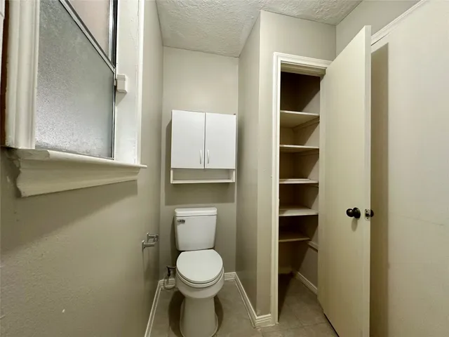 a bathroom with a toilet and a view of bathroom