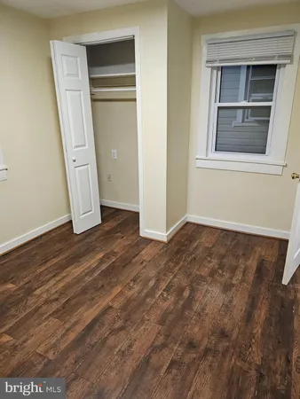 a view of a room with wooden floor and cabinet