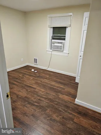 a view of an empty room and wooden floor