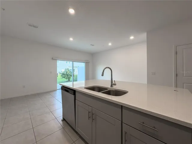 a kitchen with a sink and cabinets