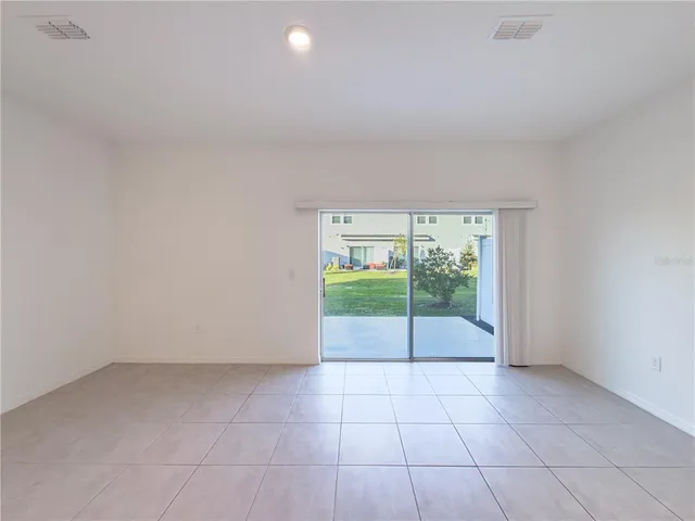 a view of an empty room with glass door