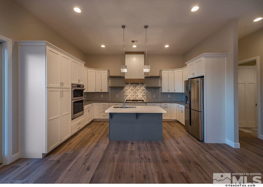 6430 Bonde Lane Reno, NV 89511 - Photo 3 of 9 a large kitchen with kitchen island a sink stainless steel appliances and cabinets