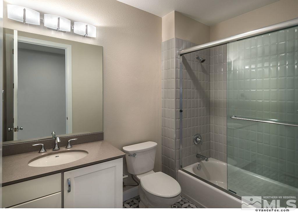 6430 Bonde Lane Reno, NV 89511 - Photo 7 of 9 a bathroom with a sink toilet a mirror and shower