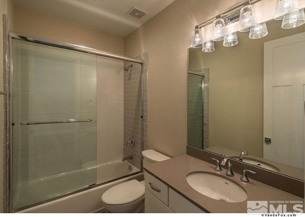 6430 Bonde Lane Reno, NV 89511 - Photo 8 of 9 a bathroom with a granite countertop sink toilet and shower