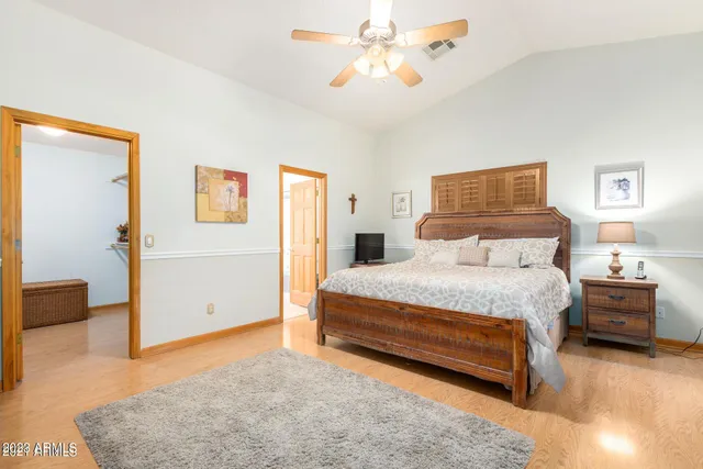 a bedroom with a bed and a chandelier