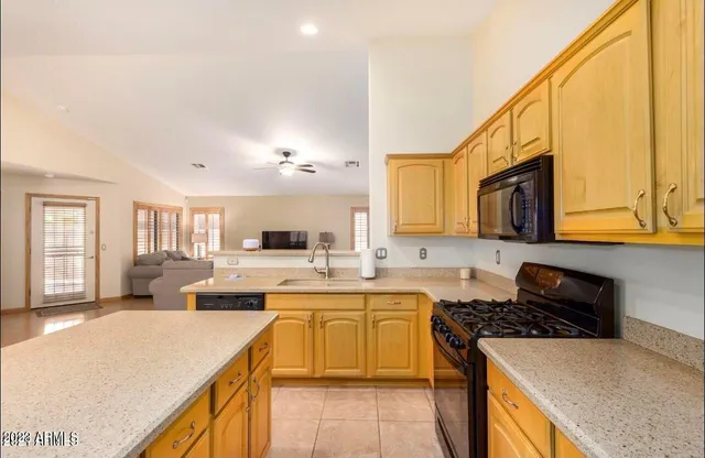 a kitchen with a sink a stove and cabinets
