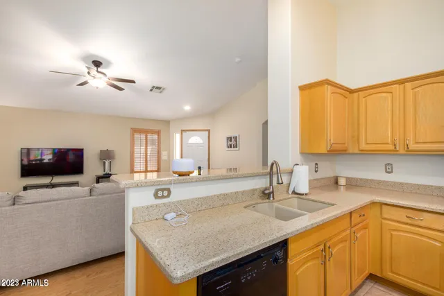 a kitchen with a sink dishwasher a stove and a refrigerator with wooden floor