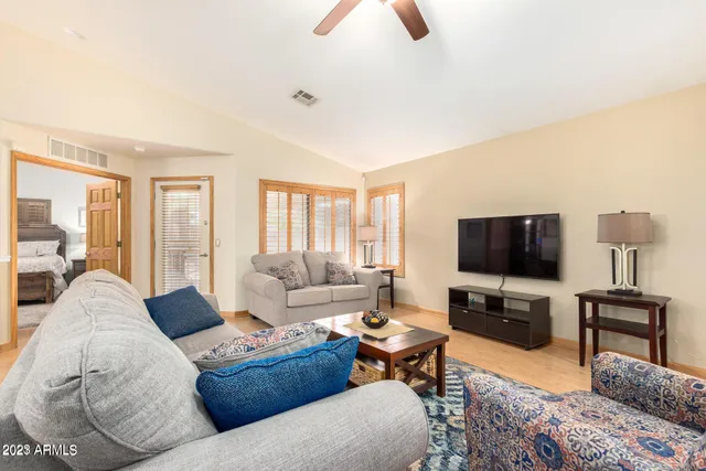 a living room with furniture and a flat screen tv