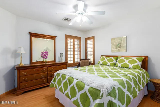 a bed sitting in a bedroom next to a window