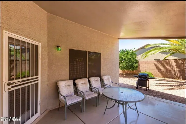 a view of a chairs and table in a patio