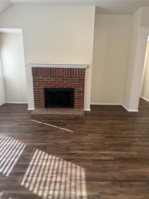 4116 Majestic Court Fort Worth, TX 76244 - Photo 14 of 37 a view of an empty room with wooden floor and a fireplace
