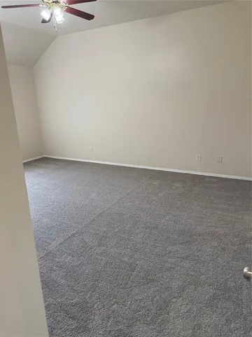 a view of empty room with a fireplace