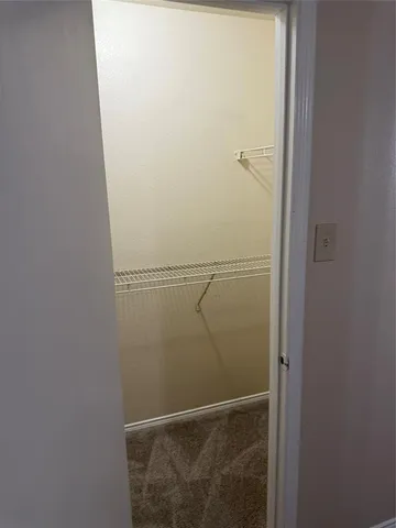 an empty room with a chandelier fan